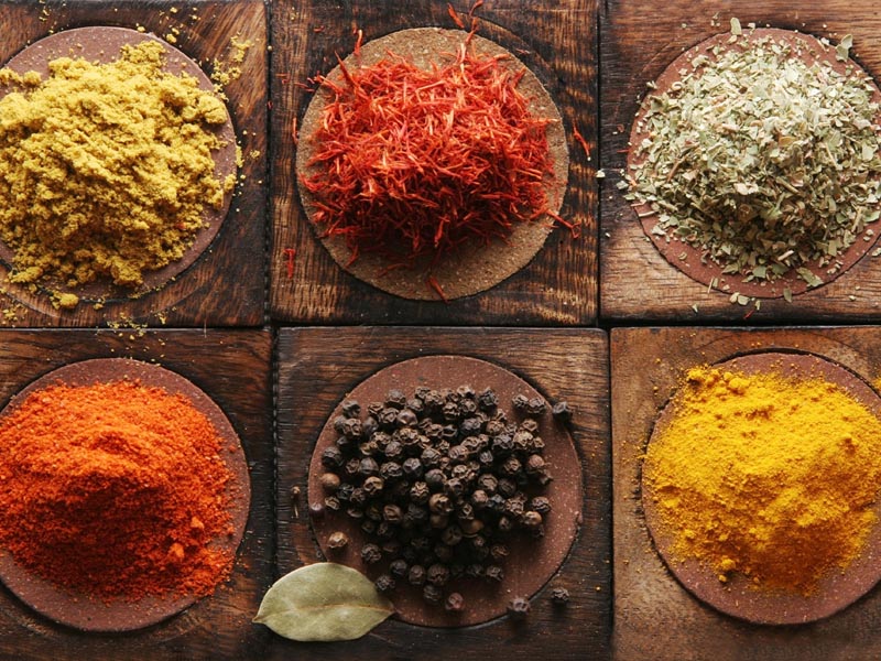 Different tipes of spice on wooden boards.